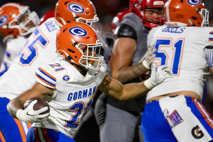 Bishop Gorman running back Jonathan Coar (21) runs the ball during the high school football gam ...