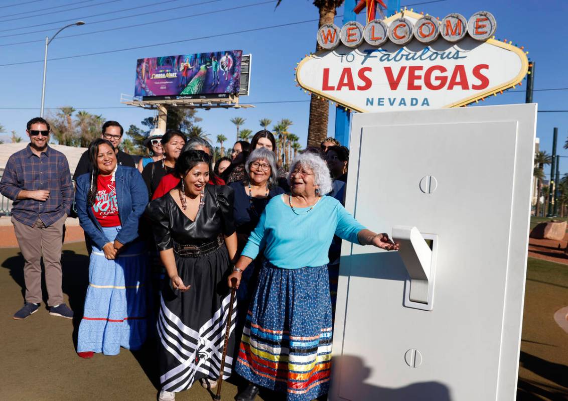 Indigenous people from varying tribes, including Lavinia Myers, right, participate in the light ...