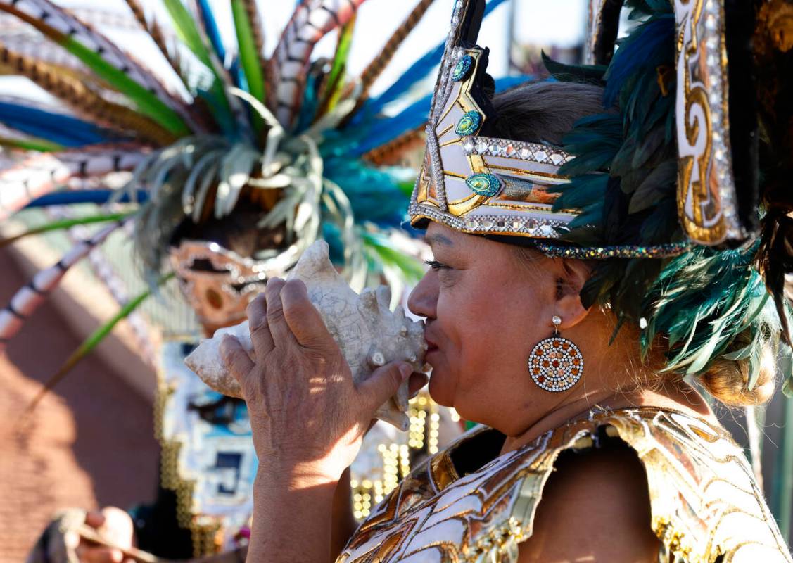 Member of the Danza Tonantzi Guadalupana Las Vegas dance group Arcely Metina blows a giant shel ...