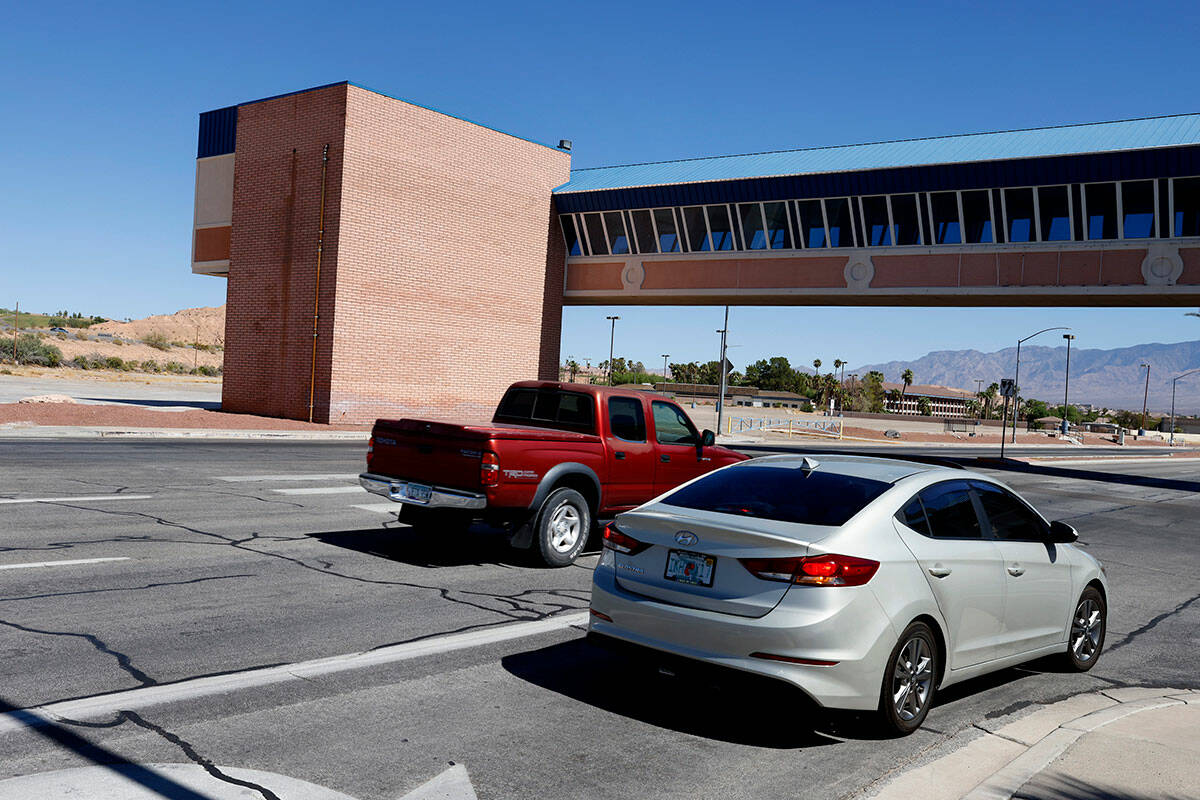 Motorists drive under the former Oasis Casino Resort's pedestrian bridge, on Tuesday, Sept. 24, ...