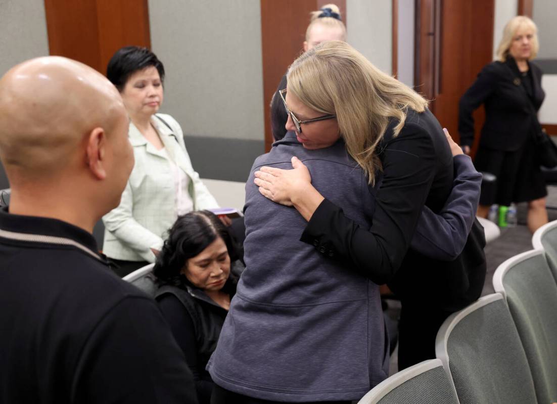 Chief Deputy District Attorney Michelle Fleck, right, hugs family members of Sang Boi Nghia and ...