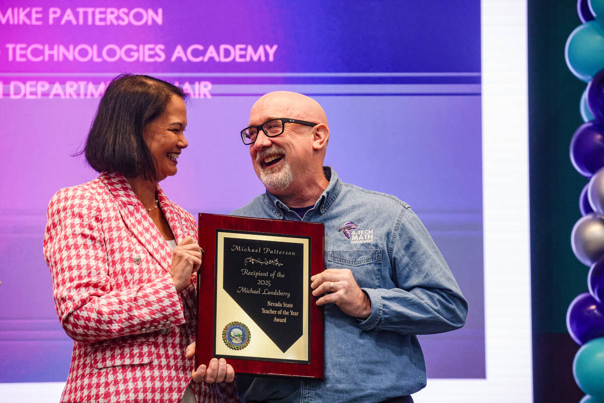 Superintendent of Public Instruction Jhone Ebert, left, holds the 2025 Nevada State Teacher of ...