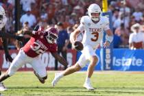 Texas Longhorns quarterback Quinn Ewers (3) runs away from Oklahoma Sooners defensive lineman R ...