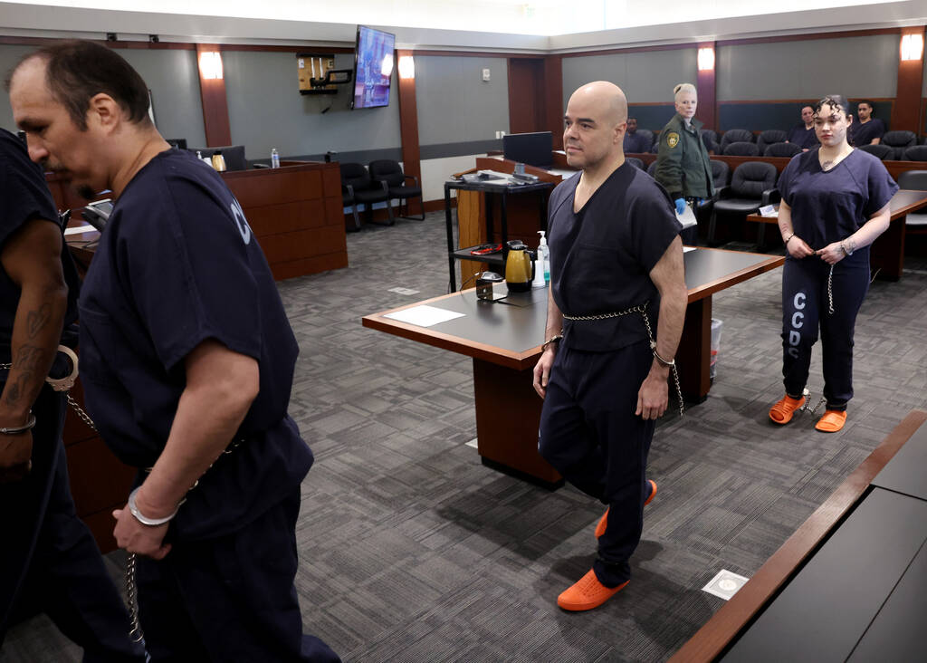 Robert Telles, center, walks out of court before a hearing at the Regional Justice Center in La ...