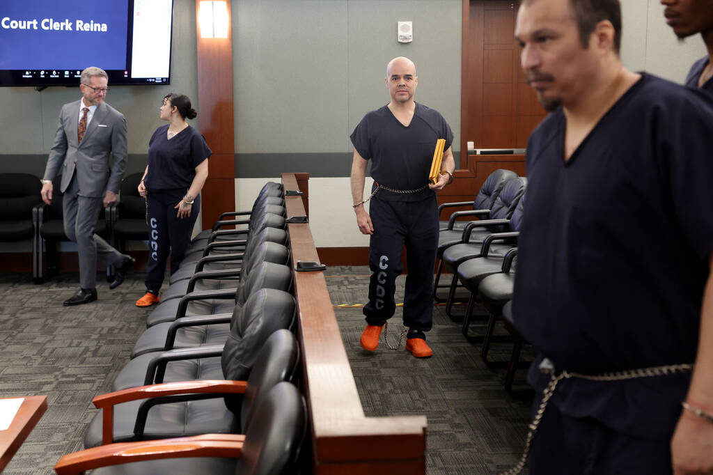 Robert Telles, center, walks out of court after a hearing at the Regional Justice Center in Las ...