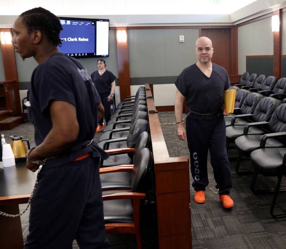 Robert Telles, center, walks out of court after a hearing at the Regional Justice Center in Las ...