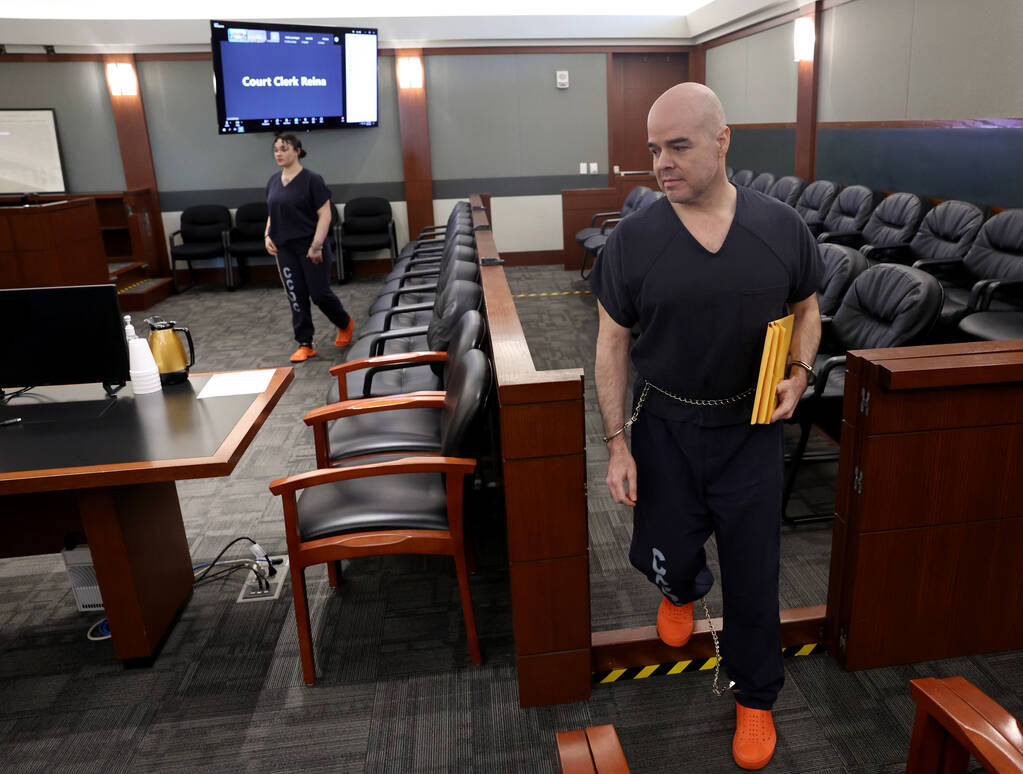 Robert Telles, center, walks out of court after a hearing at the Regional Justice Center in Las ...