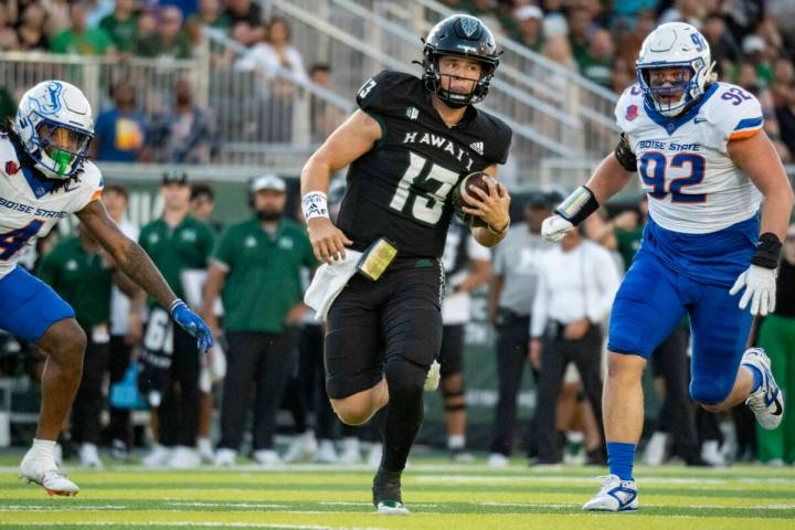 Hawaii quarterback Brayden Schager (13) runs the ball during the first half of an NCAA college ...