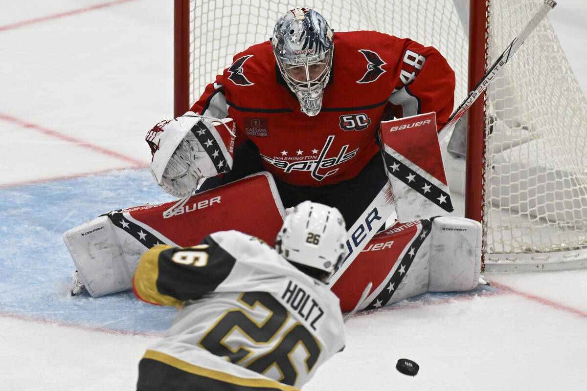 Washington Capitals goaltender Logan Thompson blocks a shot by Vegas Golden Knights right wing ...