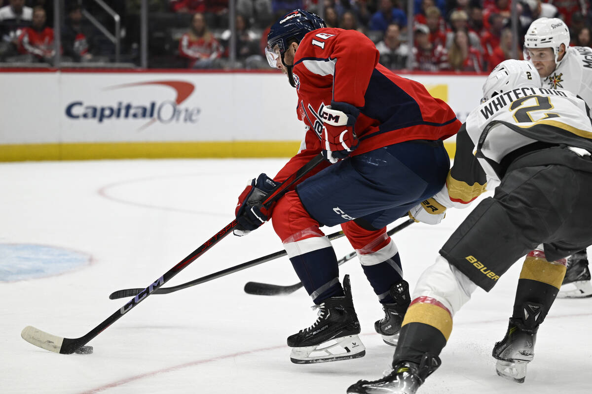 Washington Capitals right wing Taylor Raddysh, left, advances the puck towards the goal against ...