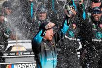 Tyler Reddick celebrates in Victory Lane after winning a NASCAR Cup Series auto race at Kansas ...