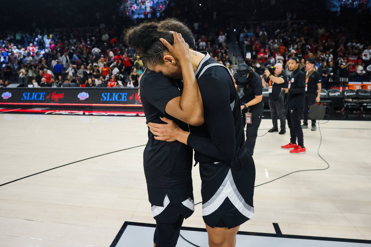 Aces teammates Sydney Colton, left, and Alysha Clark hug following a 76-62 loss during game fou ...