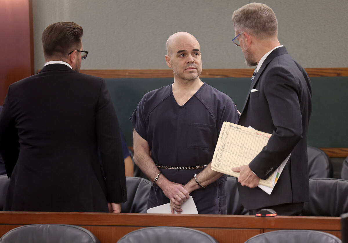 Robert Telles, center, talks to his attorneys Michael Horvath, left, and Robert Draskovich in t ...