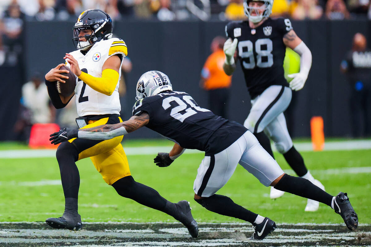 Raiders safety Isaiah Pola-Mao (20) grabs at Pittsburgh Steelers quarterback Justin Fields (2) ...