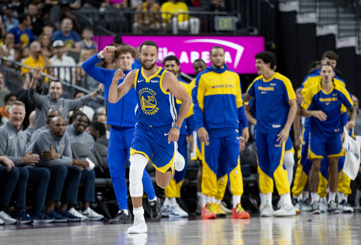 Golden State Warriors guard Stephen Curry (30) celebrates a basket during the NBA preseason bas ...