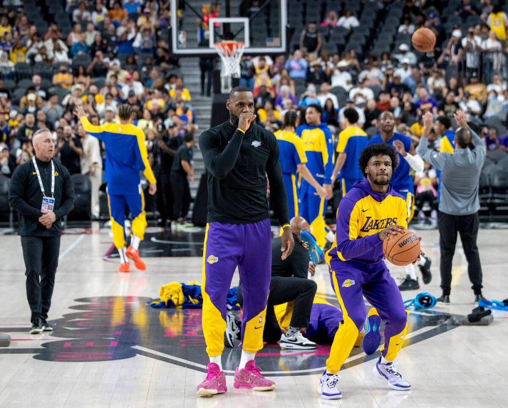 Los Angeles Lakers forward LeBron James, left, and guard Bronny James Jr., right, warmup before ...