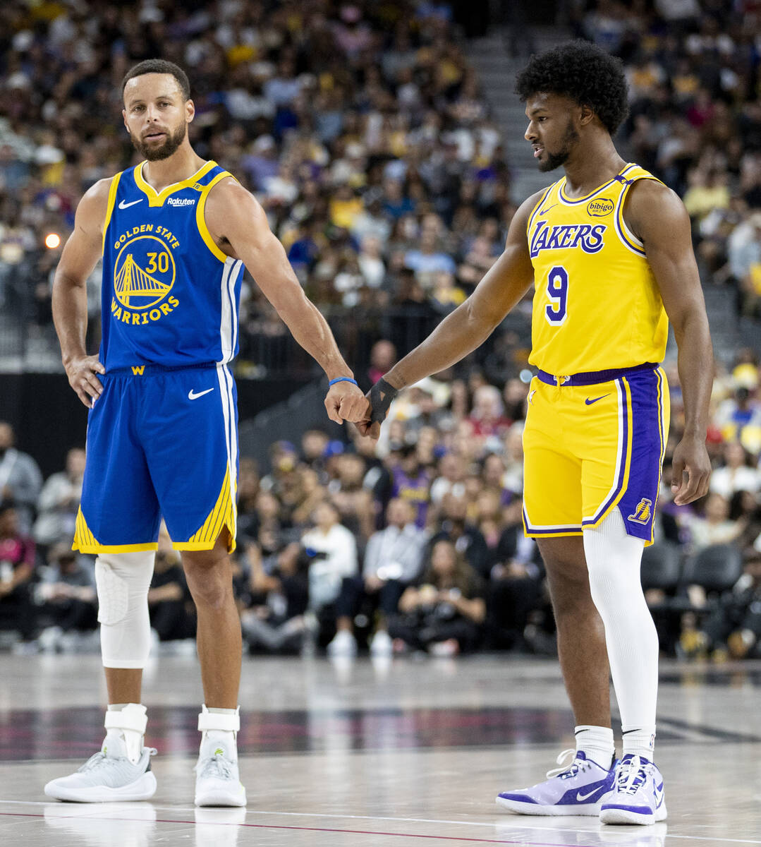 Golden State Warriors guard Stephen Curry (30) and Los Angeles Lakers guard Bronny James Jr. (9 ...