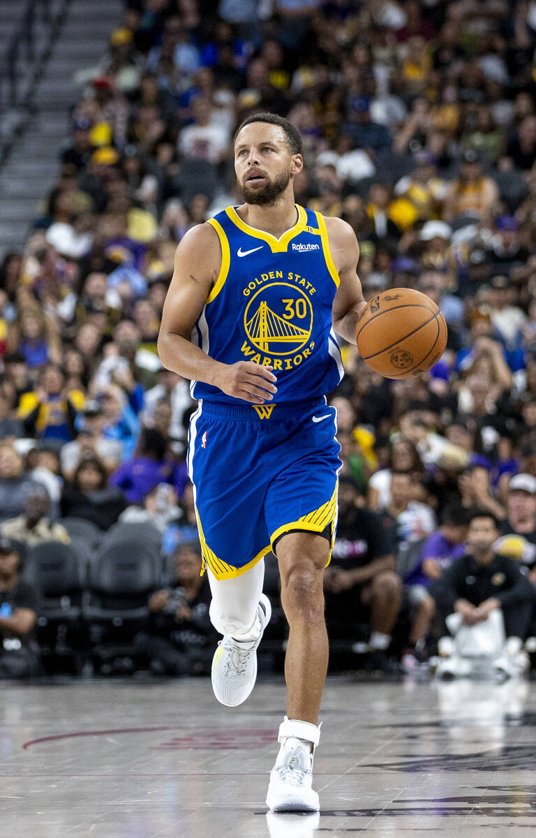 Golden State Warriors guard Stephen Curry (30) dribbles the ball down the court during the NBA ...