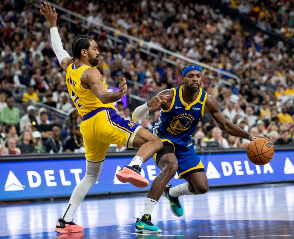 Golden State Warriors guard Buddy Hield (7) and Los Angeles Lakers guard Gabe Vincent (7) compe ...