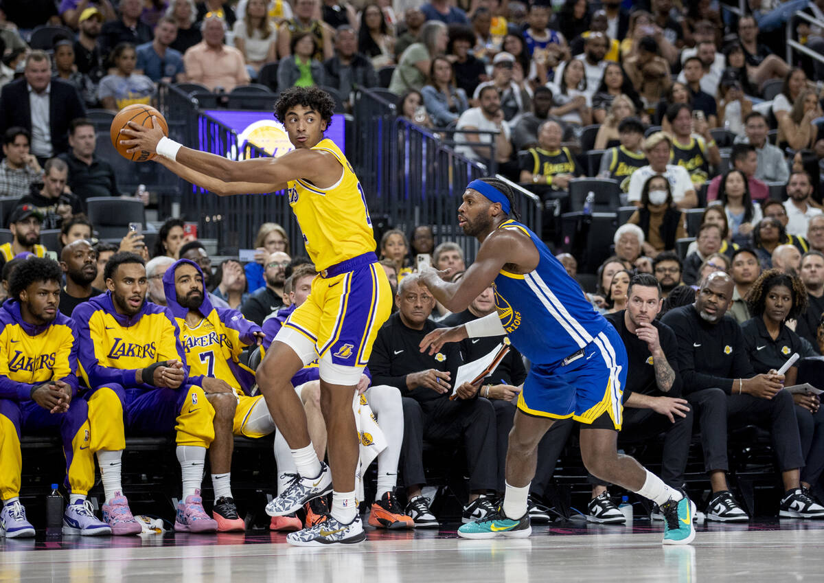 Los Angeles Lakers guard Max Christie (12) keeps the ball from Golden State Warriors guard Budd ...