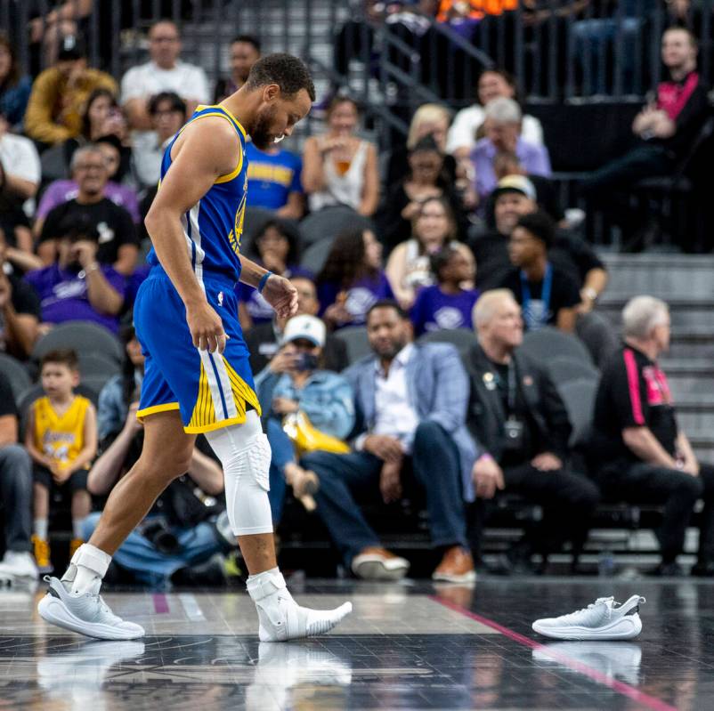 Golden State Warriors guard Stephen Curry (30) looks to grab his missing shoe during the NBA pr ...