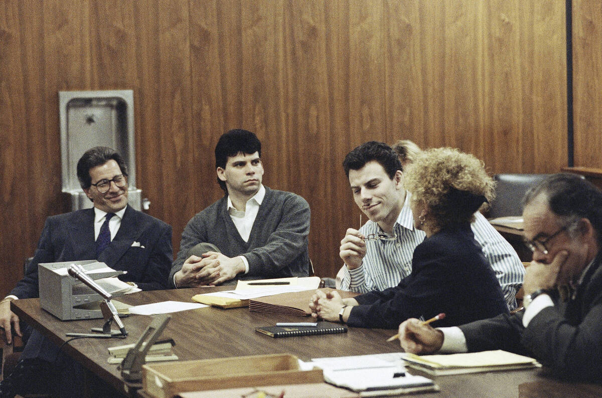 Erik Menendez, center, listens to his attorney Leslie Abramson, as his brother Lyle looks on in ...