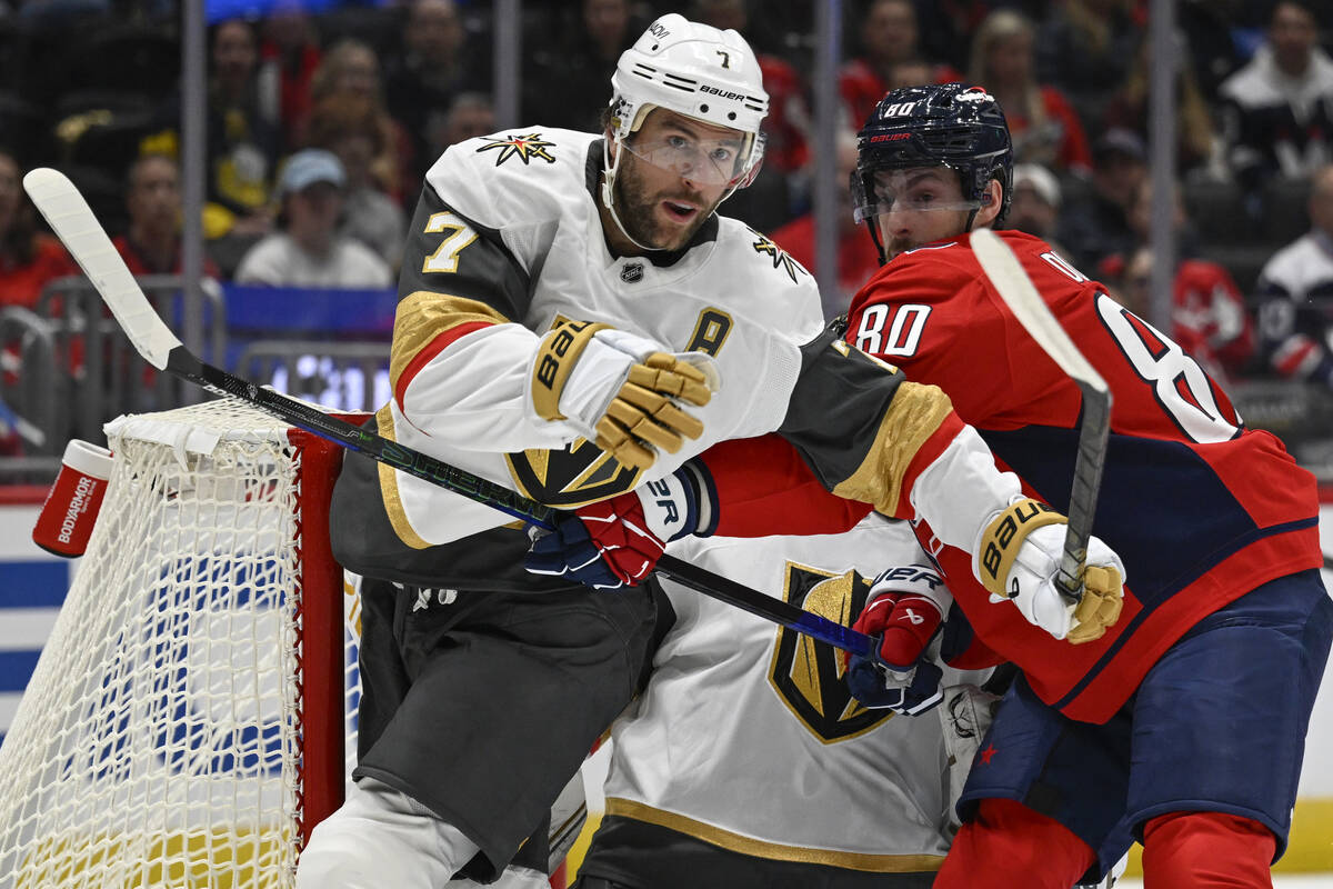 Vegas Golden Knights defenseman Alex Pietrangelo, left, battles for position with Washington Ca ...