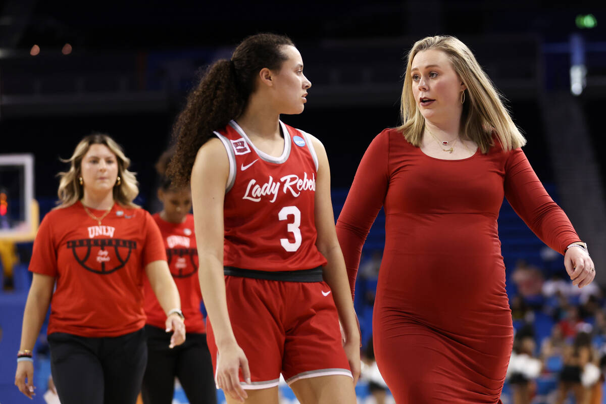 UNLV Lady Rebels head coach Lindy La Rocque speaks with guard Kiara Jackson as they head to the ...