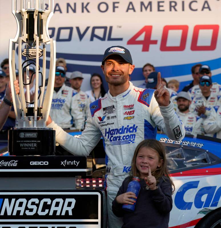 Kyle Larson poses with the trophy with his daughter Audrey, 6, after winning a NASCAR Cup Serie ...