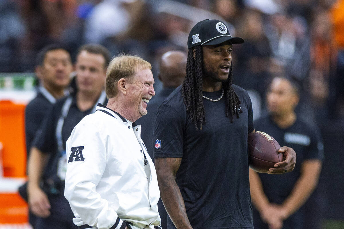 Raiders owner Mark Davis chats with wide receiver Davante Adams (17) during the warm ups of the ...