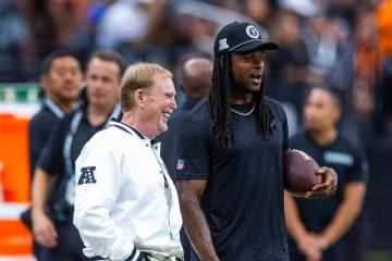 Raiders owner Mark Davis chats with wide receiver Davante Adams (17) during the warm ups of the ...