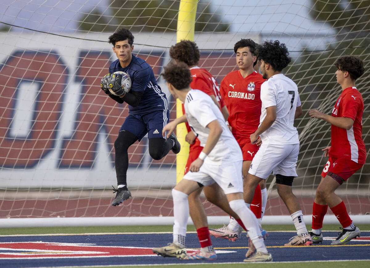 Coronado goalkeeper Logan Pierce catches a corner kick during the high school soccer game again ...