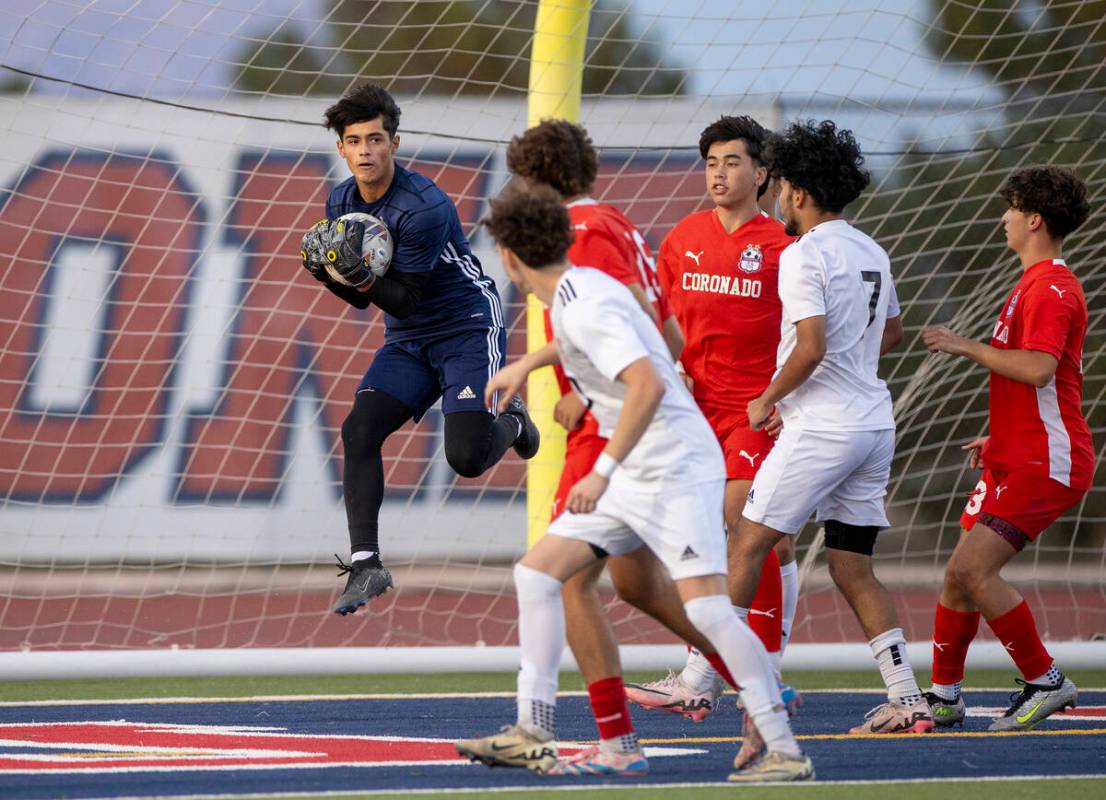 Coronado goalkeeper Logan Pierce catches a corner kick during the high school soccer game again ...