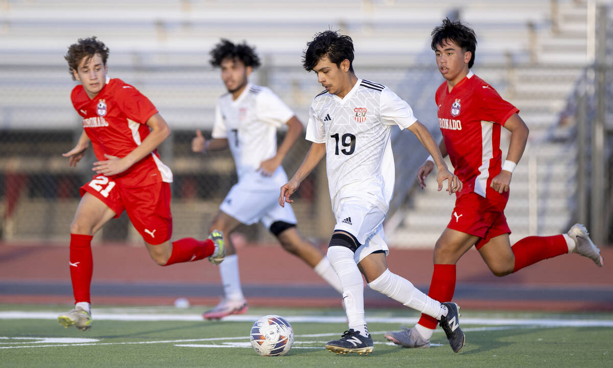 Las Vegas High junior Lex Madrigal (19) controls the ball during the high school soccer game ag ...