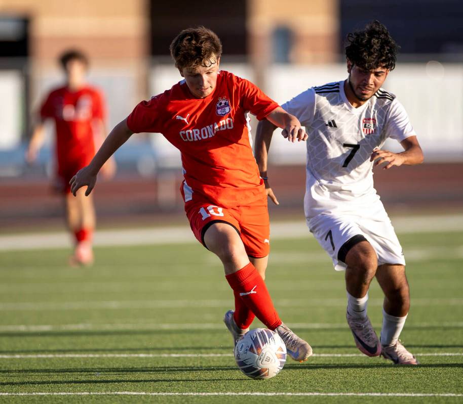 Coronado midfielder Aiden Sena (10) keeps the ball from Las Vegas High junior Anthony Cardenas ...