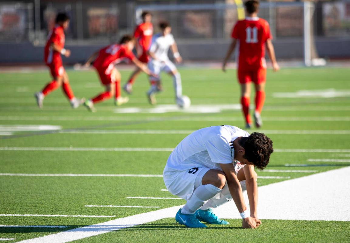 Las Vegas High junior Jonathan Avina (9) squats down after being injured during the high school ...