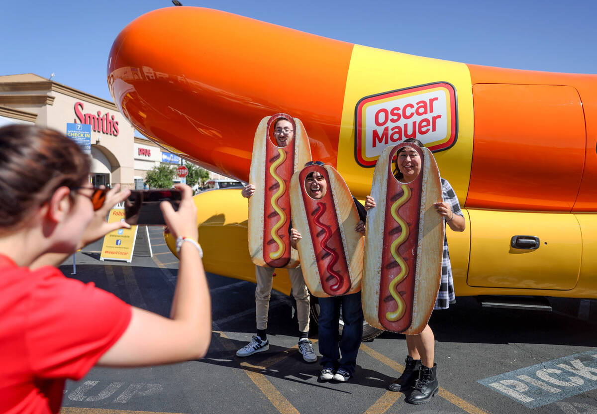 Hotdogger Ann Kerr takes a photo of Ben Mione, from left, his girlfriend Elizabeth Villagrana, ...