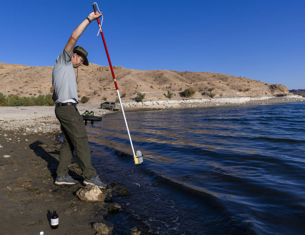 Aquatic Ecologist Riley Rackliffe with the National Park Service draws a water sample looking f ...