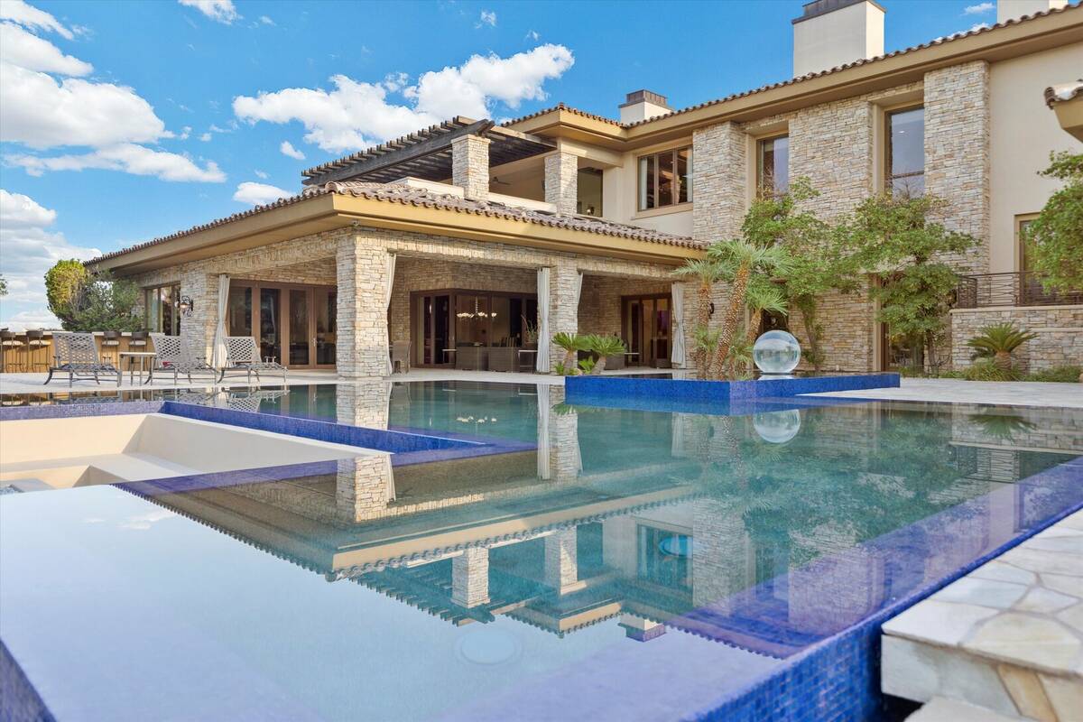 The 12,707-square-foot Southern Highlands house has five bedrooms, eight bathrooms and a five-c ...