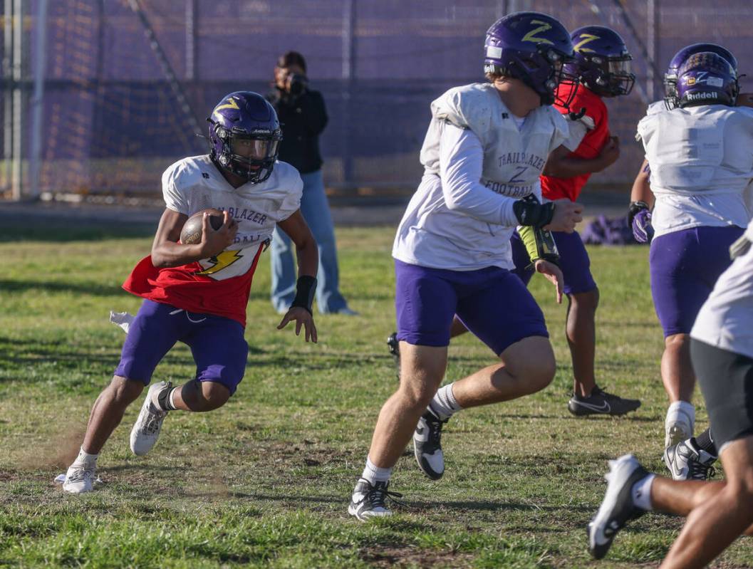 Running back Makai Miller runs with the ball during football practice at Durango High School in ...