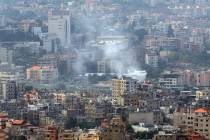 Smoke rises from the site of an overnight Israeli airstrike in the Dahieh neighborhood on Oct. ...