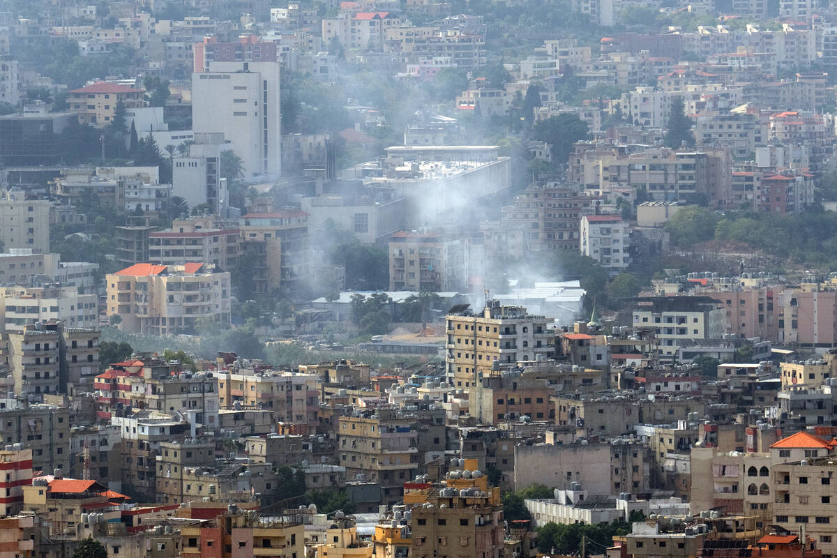 Smoke rises from the site of an overnight Israeli airstrike in the Dahieh neighborhood on Oct. ...