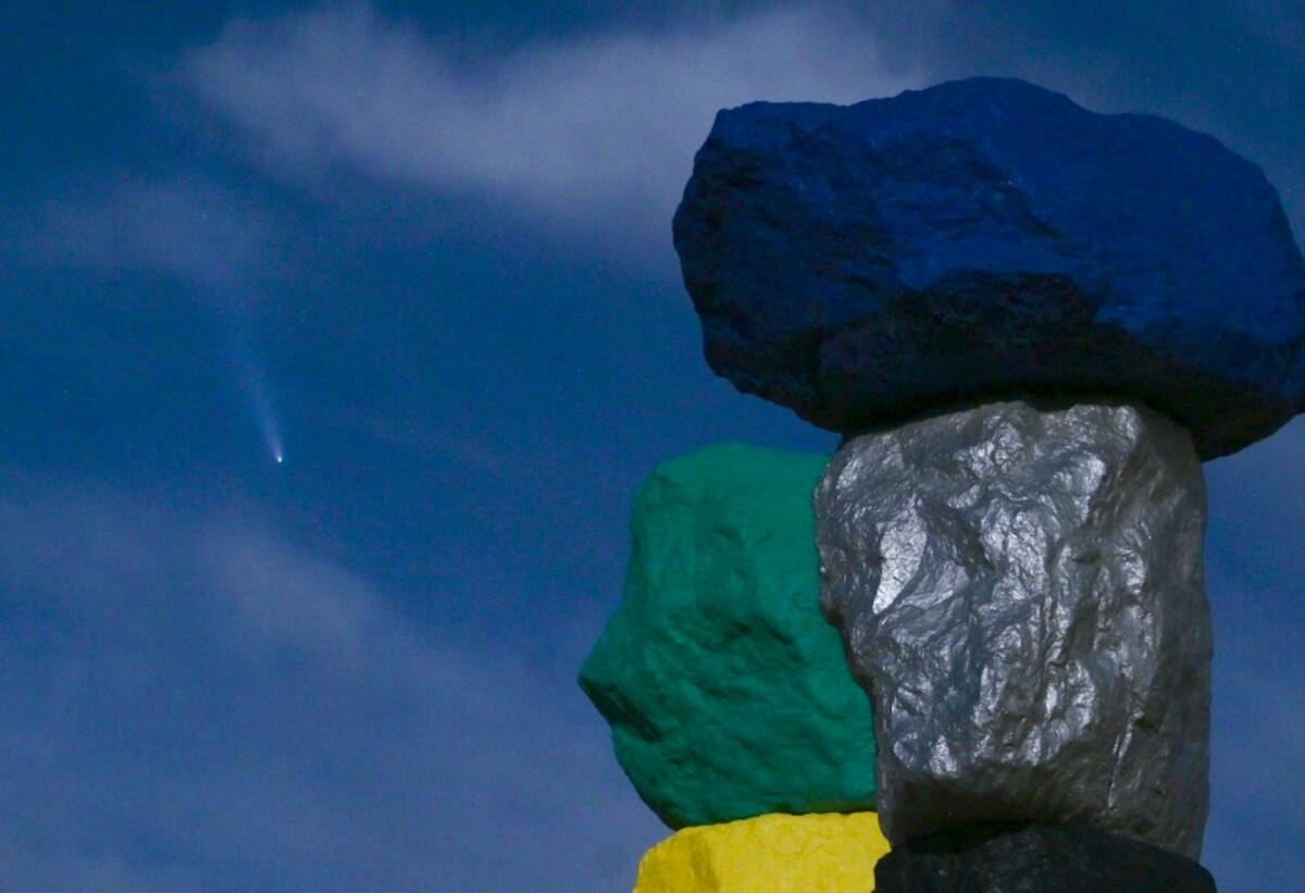 "Seven Magic Mountains," by artist Ugo Rondinone, is illuminated by a supermoon as Comet Tsuchi ...