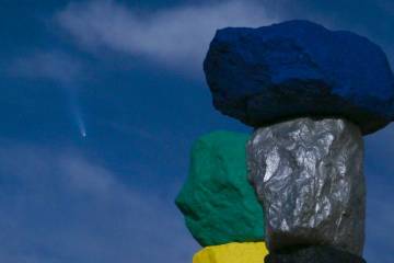 "Seven Magic Mountains," by artist Ugo Rondinone, is illuminated by a supermoon as Comet Tsuchi ...