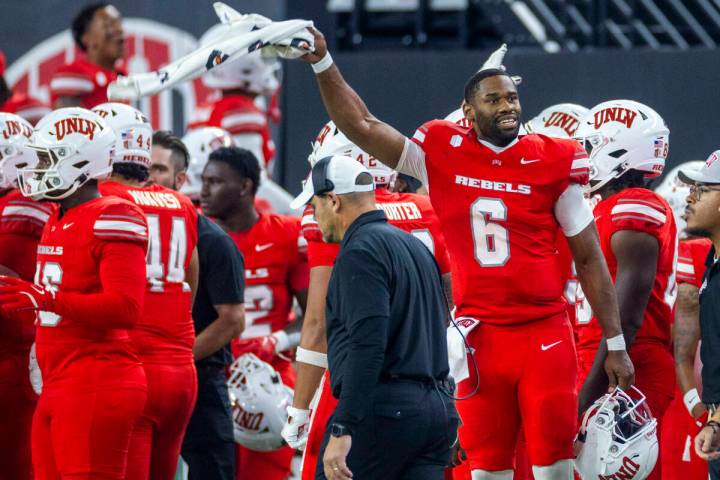 UNLV quarterback Hajj-Malik Williams (6) cheers for his defense while pumping up the crowd agai ...