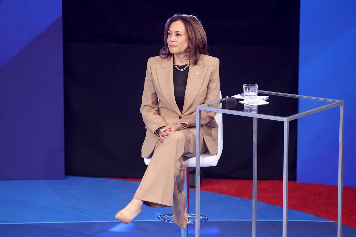 Vice President Kamala Harris takes a seat during a commercial break in a town hall with Latino ...