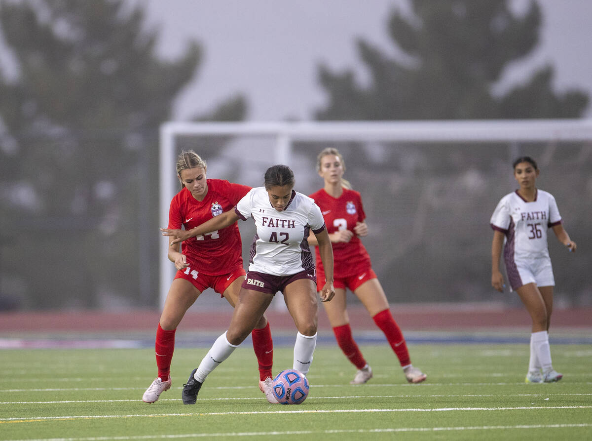 Faith Lutheran midfielder Jailynn Henry (42) and Coronado midfielder Allison Kleiner (14) compe ...