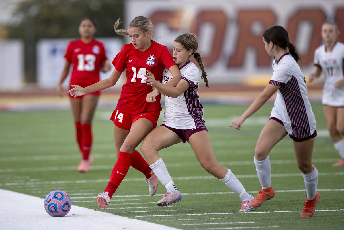 Coronado midfielder Allison Kleiner (14) and Faith Lutheran forward Olivia Stark (8) compete fo ...