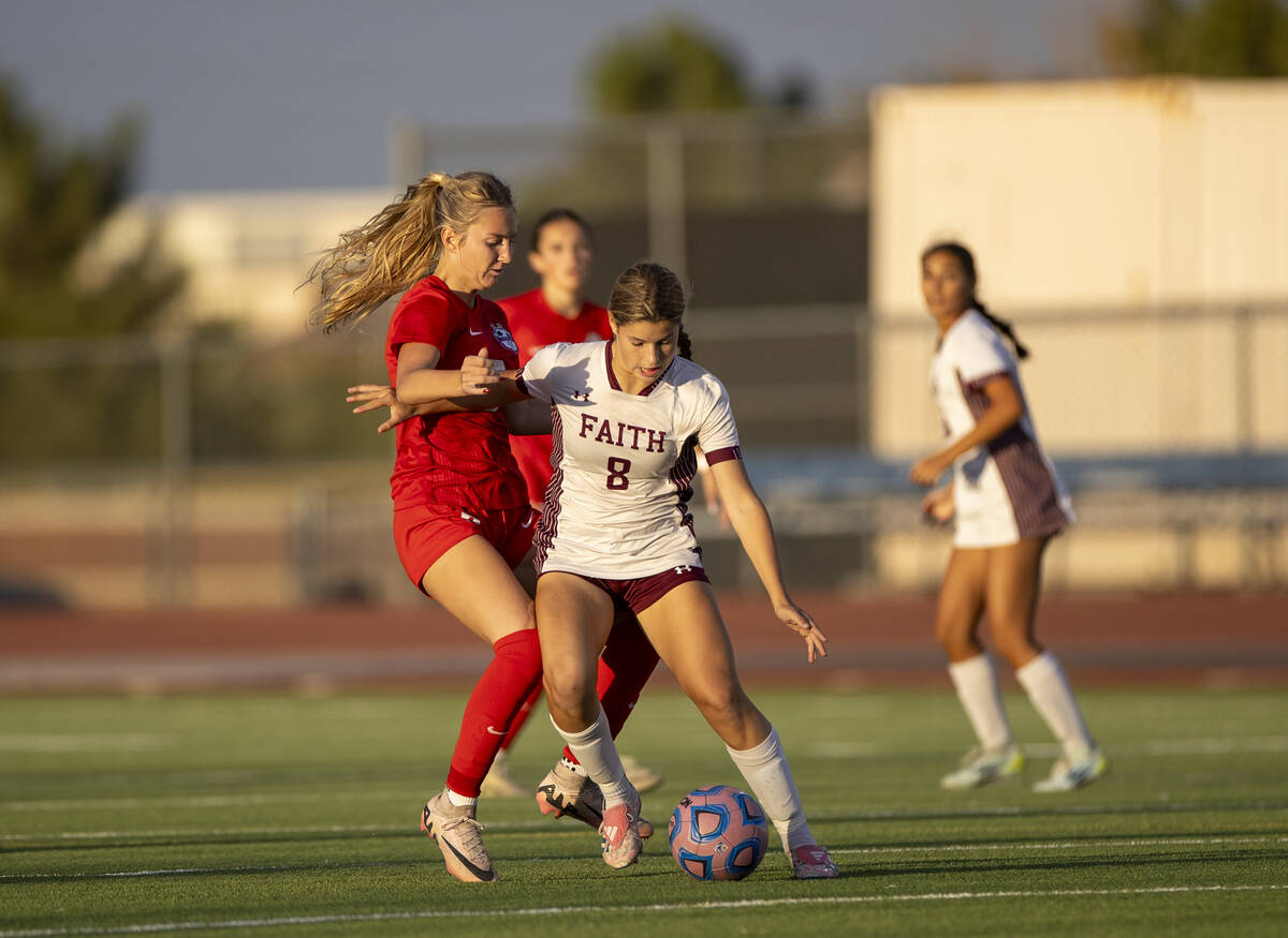 Faith Lutheran forward Olivia Stark (8) attempts to keep the ball from Coronado midfielder Alex ...