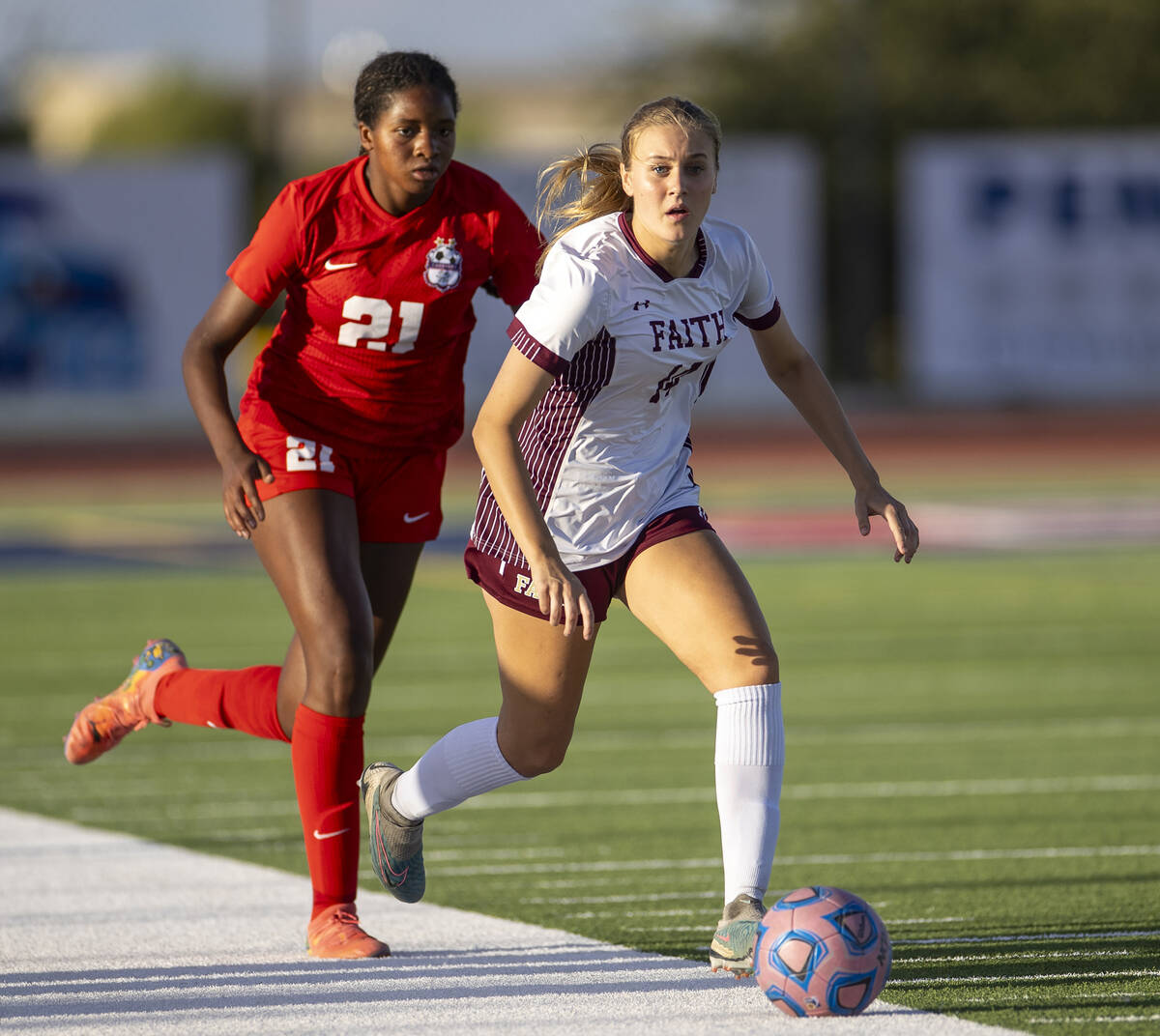 Faith Lutheran defender Kloe Abdalla (14) kicks the ball away from Coronado forward Jazmine Mcc ...